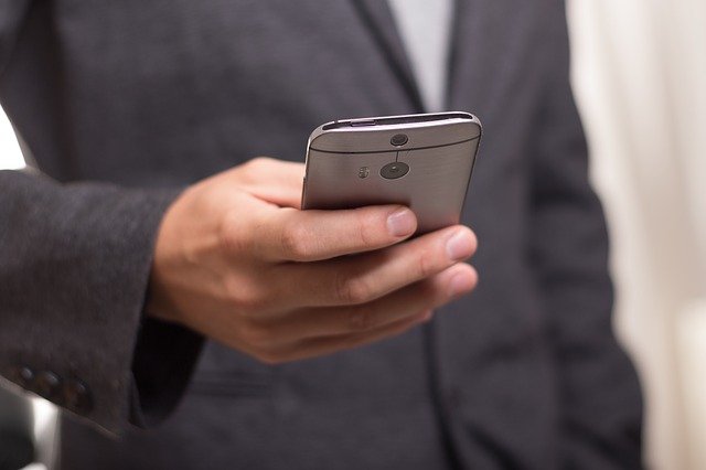 Man using phone to view an email marketing message